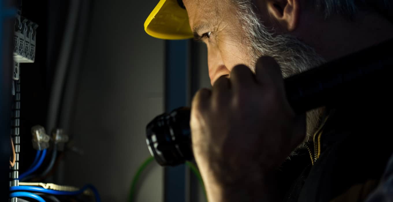 Contractor working after hours with phone in hand